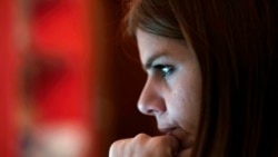 Andreia Sampaio sits at her computer as she works from home, in Lisbon, Nov. 26, 2021.