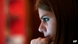 Andreia Sampaio sits at her computer as she works from home, in Lisbon, Nov. 26, 2021.