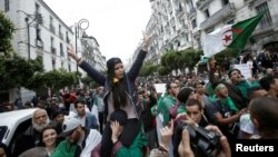 Demonstrators hold flags and banners during peaceful anti-government protests in Algiers, Algeria, May 3, 2019. 