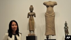 Dr. Melody Rod-ari stands near Khmer statues at the "Where Art Meets Science" exhibition at Norton Simom Museum in Pasadena, California on July 1, 2011. Where Art Meets Science exhibition displays ancient sculptures from the Hindu-Buddhist World.