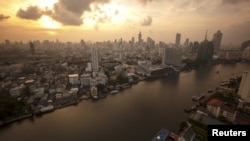 The skyline of central Bangkok and the Chao Phraya river are seen during sunrise in Bangkok, Thailand, April 22, 2015. 