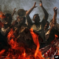 Protesters yell anti-American slogans while burning a poster of Pakistan Prime Minister Yousuf Raza Gilani, to condemn the government's support of the U.S., Multan, November 29, 2011