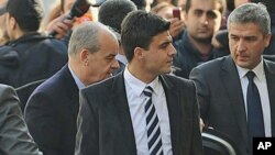 Turkey's former Chief of Staff General Ilker Basbug, center left, is surrounded by security officials as he arrives at a prosecutor's office in Istanbul, Turkey, January 5, 2012.
