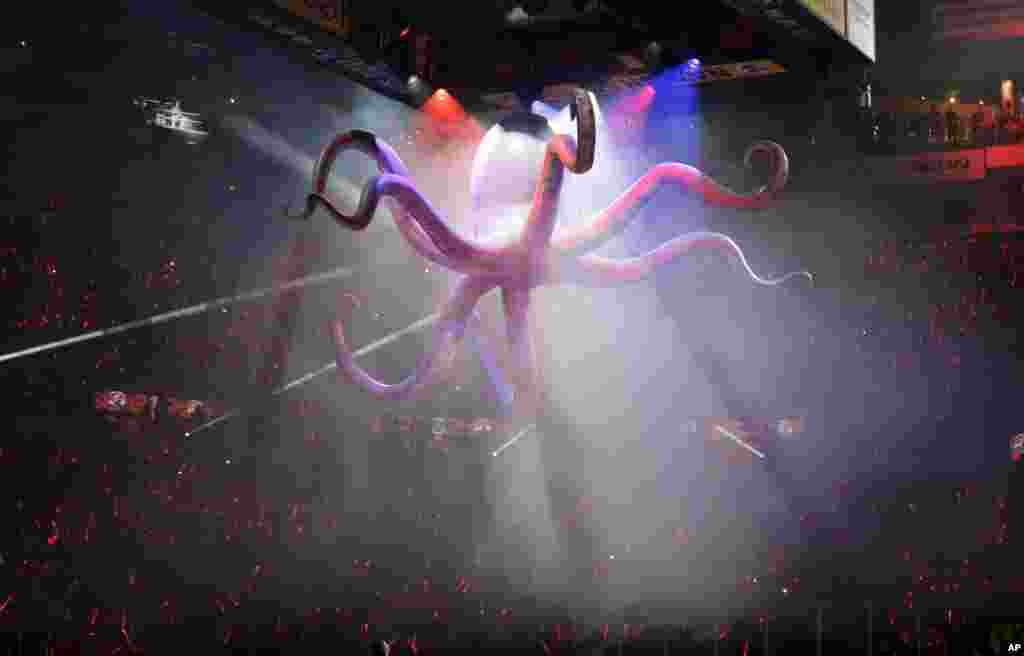 An octopus is lowered during a pre-game ceremony in Game 3 of a first-round NHL hockey playoff series between the Detroit Red Wings and the Boston Bruins in Detroit, April 22, 2014.