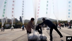 FILE - North Korean defectors prepare to release balloons carrying leaflets condemning North Korean leader Kim Jong Un and his government's policies, in Paju, near the border with North Korea, South Korea, Oct. 10, 2014. 
