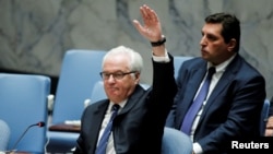 Russian Ambassador Vitaly Churkin vetoes a draft resolution that demanded an immediate end to airstrikes and military flights over Aleppo, Syria, at U.N. Headquarters in New York, Oct. 8, 2016.