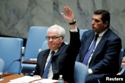 Russian Ambassador Vitaly Churkin vetoes a draft resolution that demanded an immediate end to airstrikes and military flights over Aleppo, Syria, at U.N. Headquarters in New York, Oct. 8, 2016.