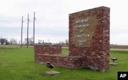 FILE - This March 25, 2017, photo shows a sign for the Department of Correction's Cummins Unit prison in Varner, Ark.