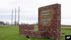 This March 25, 2017, file photo shows a sign for the Department of Correction's Cummins Unit prison in Varner, Ark.