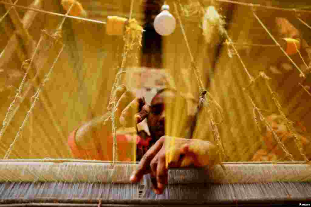 A man knits traditional Banarasi Saree in Dhaka, Bangladesh.