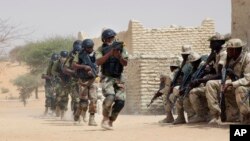 FILE - Nigerien special forces and Chadian troops participate with U.S. advisers in the Flintlock exercise in Mao, Chad, March 7, 2015.