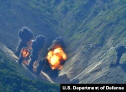 Bombs dropped by U.S. Air Force B-1B bombers, F-35 stealth fighter jets and South Korean F-15 fighter jets hit a simulated target as they fly over the Korean Peninsula, South Korea, Thursday, Aug. 31, 2017.