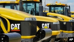 FILE - Earth-moving tractors and equipment made by Peoria, Illinois-based Caterpillar Inc. are seen in Clinton, Illinois, June 20,2012. Caterpillar's recent decision to move 300 top headquarters jobs to the Chicago area made Peoria the latest city with a vacuum to fill.