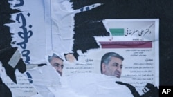 Torn electoral posters are seen on a wall in central Tehran, Iran, March 3, 2012. 