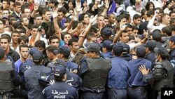 University students face police officers as they demonstrate in Algiers. Students were protesting for increased freedom, April, 11, 2011