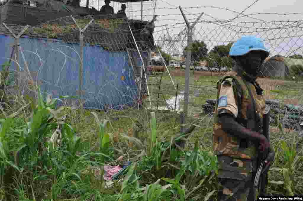 A U.N. peacekeeper stands guard at the U.N. Mission in South Sudan (UNMISS) base in Malakal, where some 19,000 people have been sheltering for nearly half a year.