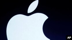 FILE - The Apple logo is projected during an announcement in San Francisco.