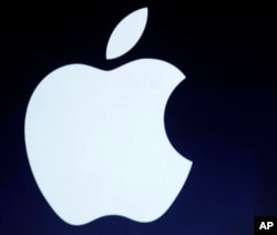 The Apple logo is projected during an announcement in San Francisco.