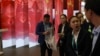 Attendees stand near a display of the Chinese flag during the China International Import Expo in Shanghai, Nov. 6, 2018.