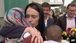 In this image made from video, New Zealand's Prime Minister Jacinda Ardern, center, hugs and consoles a woman as she visited Kilbirnie Mosque to lay flowers among tributes to Christchurch attack victims, in Wellington, March 17, 2019.