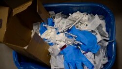 File photo show a view of a waste basket with syringes and gloves after residents received a dose of the third Pfizer COVID-19 vaccine, at San Jeronimo nursing home, in Estella, northern Spain, Sept. 23. 2021.