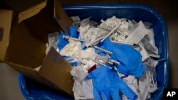 File photo shows a view of a garbage basket with syringes and gloves as residents received a dose of the third Pfizer COVID-19 vaccine, at the San Jeronimo Nursing Home, Estella, northern Spain, September 23. 2021.