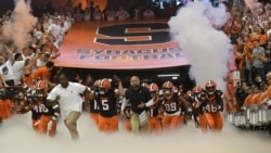 Syracuse team enters the Carrier Dome during the NCAA college football game Saturday, Sept. 14, 2019, in Syracuse, N.Y. (AP Photo/Steve Jacobs)