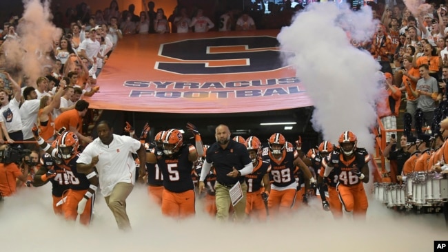 Syracuse team enters the Carrier Dome during the NCAA college football game Saturday, Sept. 14, 2019, in Syracuse, N.Y. (AP Photo/Steve Jacobs)