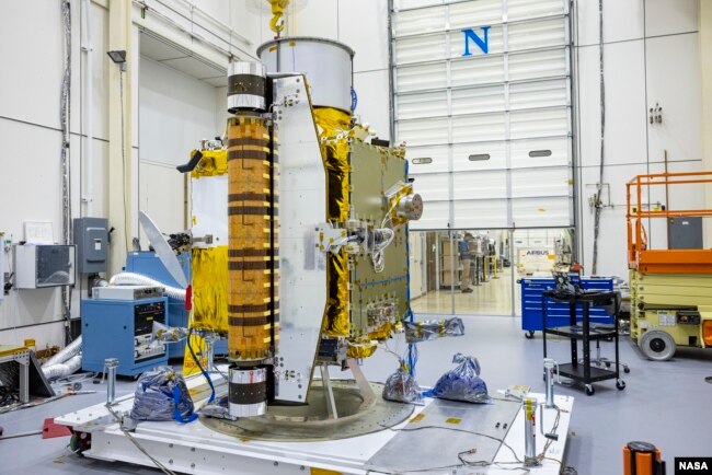 Members of the DART team carefully inspect the spacecraft before performing vibration tests in July 2021. (Image Credit: NASA/Johns Hopkins APL/Ed Whitman)