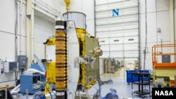 Members of the DART team carefully inspect the spacecraft before performing vibration tests in July 2021. (Image Credit: NASA/Johns Hopkins APL/Ed Whitman)