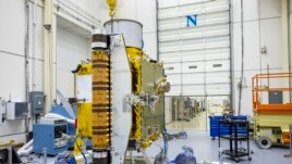 Members of the DART team carefully inspect the spacecraft before performing vibration tests in July 2021. (Image Credit: NASA/Johns Hopkins APL/Ed Whitman)