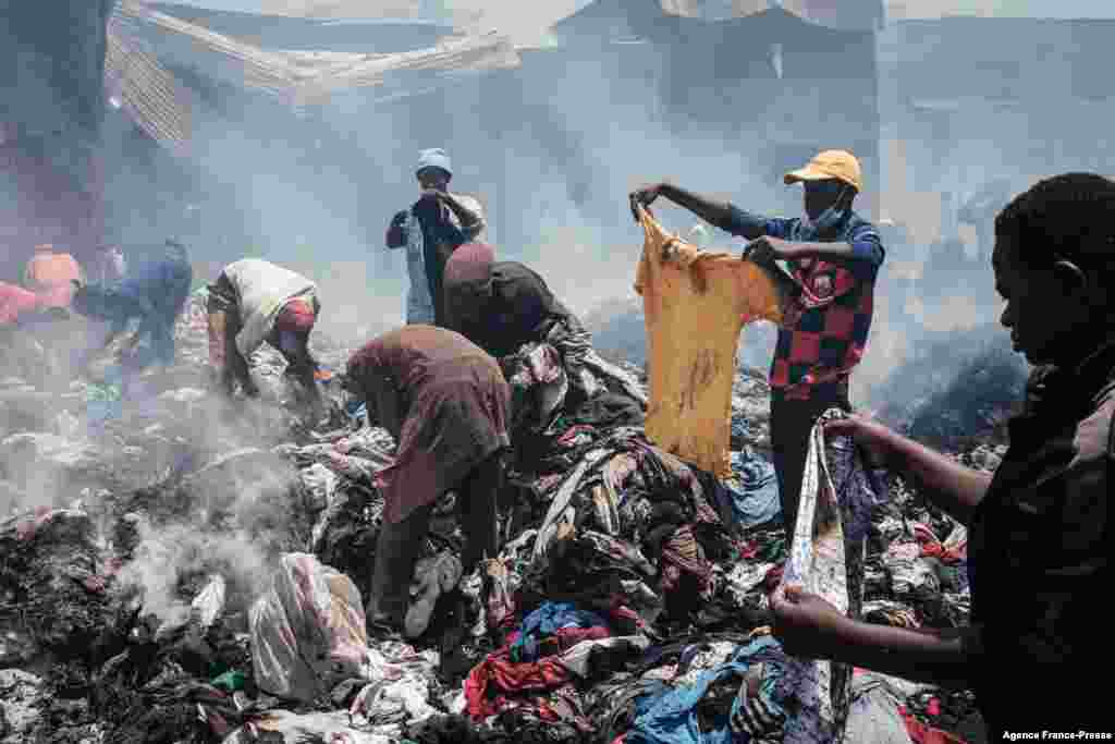 Traders look for and collect clothes from remains burned down by a fire in the early morning at Gikomba market, East Africa&#39;s largest second-hand clothing market, in Nairobi, Kenya.