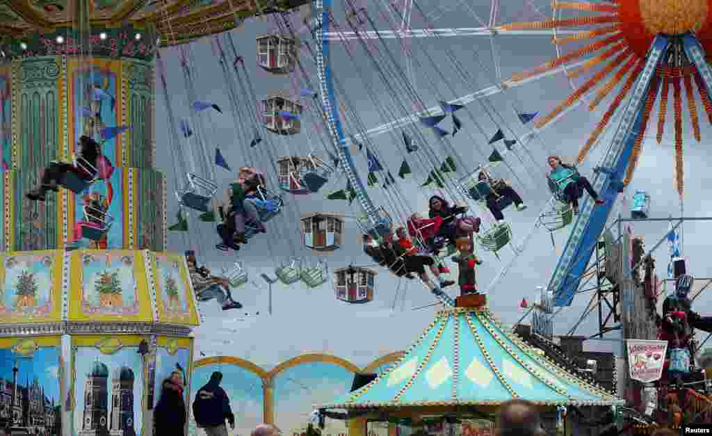 Visitors enjoy a swing ride during the last day of the 184th Oktoberfest in Munich, Germany.