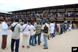 Election workers count presidential votes at a polling station in Libreville, Aug. 30, 2009.