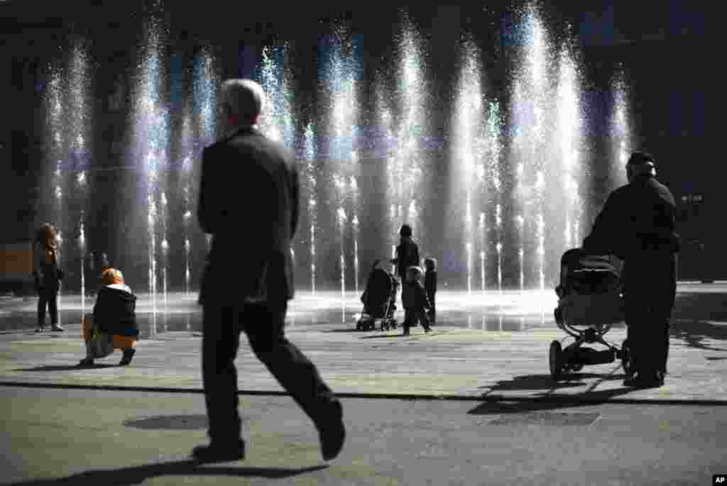 People watch a water fountain on the Swiss Federal square in Bern, Switzerland March 21, 2012. World Water Day, which is celebrated on March 22, aims to focus on water and food security. (Reuters)