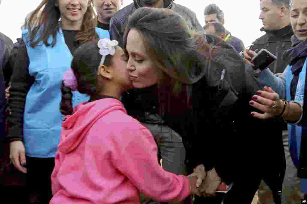 The U.N. refugee agency&#39;s special envoy, actress Angelina Jolie, kisses a Syrian child during her visit to the Zaatari Syrian Refugee Camp, in Mafraq, Jordan.