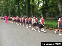 Schoolchildren walk through a road in Hanoi. Advocates say feminism should be taught to any gender, such as by encouraging compassion in boys.