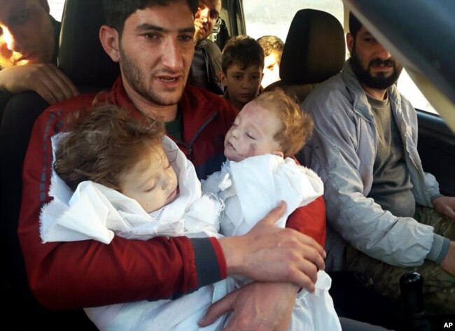Abdul-Hamid Alyousef, 29, holds his twin babies who were killed during a suspected chemical weapons attack, in Khan Sheikhoun in the northern province of Idlib, Syria, April 4, 2017.