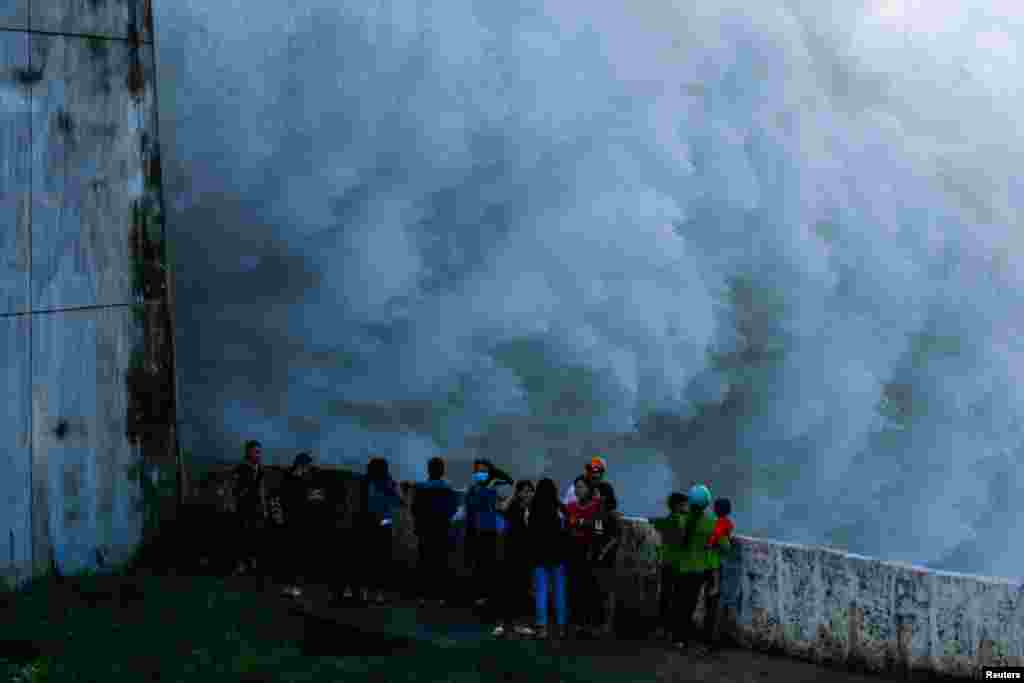 People watch as Hoa Binh hydroelectric power plant opens the flood gates after a heavy rainfall caused by a tropical depression in Hoa Binh province outside Hanoi, Vietnam, October 12, 2017.