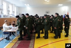 FILE - Russian soldiers line up to get their ballots in the presidential election in Rostov-ojn-Don, Russia, March 18, 2018.