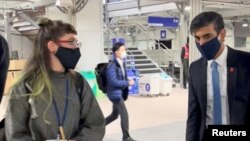 A young climate activist questions Britain's Chancellor of the Exchequer Rishi Sunak on climate change policies as the UN Climate Change Conference (COP26) takes place, in Glasgow, Scotland, Britain, Nov. 3, 2021