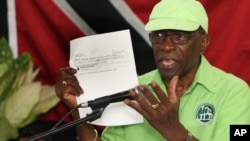 Former FIFA Vice President Jack Warner holds a copy of a check while he speaks at a political rally in Marabella, Trinidad and Tobago, June 3, 2015. 