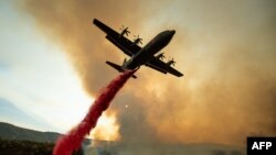 An air tanker drops retardant on the Ranch Fire, part of the Mendocino Complex Fire, burning along High Valley Rd near Clearlake Oaks, California.