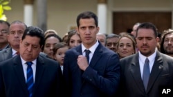 Lawmakers Juan Guaido, center, President of National Assembly, Edgar Zambrano, left, first Vice President and Stalin Gonzalez, right, second Vice President pose after being sworn in during a special session at the National Assembly in Caracas, Venezuela, Jan. 5, 2019.