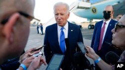 President Joe Biden speaks to members of the media before boarding Air Force One at Bradley International Airport, in Windsor Locks, Conn., Oct. 15, 2021. 