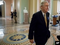 FILE - Senate Majority Leader Mitch McConnell of Kentucky walks to the Senate Chamber on Capitol Hill in Washington, July 25, 2017.