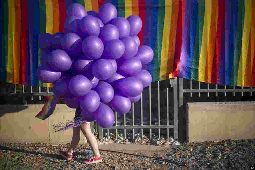 A woman holds balloons as she participates in the first Gay Pride Parade in Beersheba, Israel, June 22.