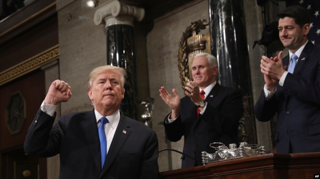 도널드 트럼프 미국 대통령(왼쪽)이 30일 의회에서 첫 국정연설을 마친 후 주먹을 들어보이고 있다. 마이크 펜스 미국 부통령(가운데)과 폴 라이언 하원의장이 박수를 보내고 있다.