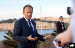FILE - European Council President Donald Tusk speaks with the media prior to an EU summit outside his hotel in Valletta, Malta, Feb. 2, 2017.