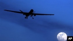 A U.S. Predator drone flies over the moon above Kandahar Air Field, southern Afghanistan (File Photo)
